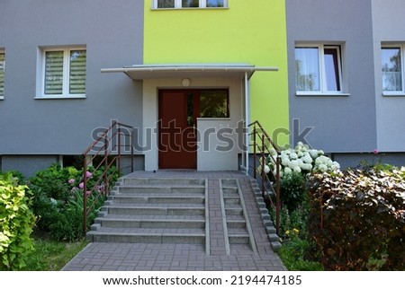 The entrance to the staircase with the close door - view of the apartment block