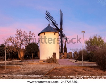 Entrance to the town of Villarrobledo with a beautiful orange and orange sunrise illuminating the beautiful windmill of the land of Don Quixote.