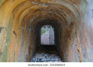 Entrance of tunnel caused by drilling in a cave and concrete cover in the mountains for connection between outside and sunlight  background. - Shutterstock ID 2312060615