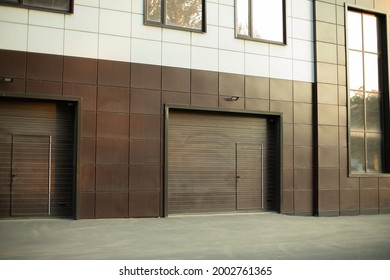 Entrance To The Underground Garage. The Gate To The Garage In The Building. The Office Building Is Brown. A Modern Facing Panel For A Technical Structure. Windows In A Private Office.