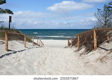 entrance to the wide beach in Stilo with the white sand, Baltic sea, Poland - Shutterstock ID 2310371867