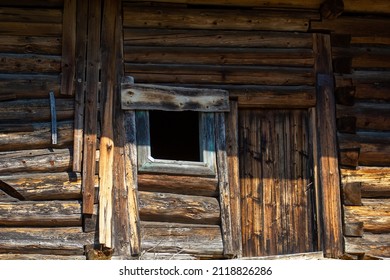 Entrance and window of abandoned old log house in Slovak mountain village - Shutterstock ID 2118826286
