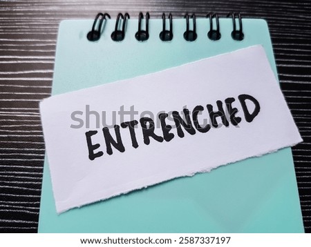 Entrenched writting on table background.