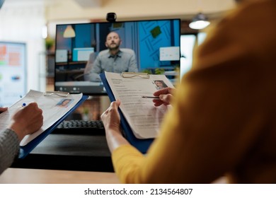 Entrepreneur analyzing worker cv discussing hiring plan with remote manager during online videocall conference meeting. Team working at company strategy discussing partnership in startup office - Shutterstock ID 2134564807