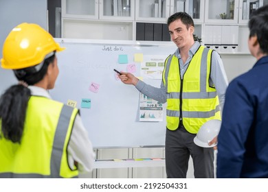 Entrepreneur Brainstorming Ideas With His Competent Engineers In The Office. Architectural Investors And Engineers Working On An Upcoming Project In A Fun And Friendly Environment.