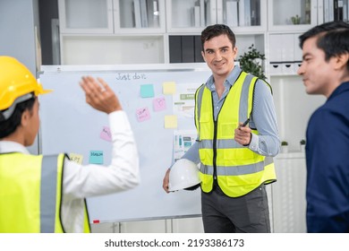 Entrepreneur Brainstorming Ideas With His Competent Engineers In The Office. Architectural Investors And Engineers Working On An Upcoming Project In A Fun And Friendly Environment.