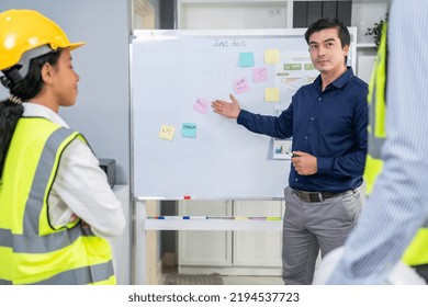 Entrepreneur Brainstorming Ideas With His Competent Engineers In The Office. Architectural Investors And Engineers Working On An Upcoming Project In A Fun And Friendly Environment.