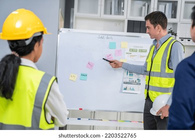 Entrepreneur Brainstorming Ideas With His Competent Engineers In The Office. Architectural Investors And Engineers Working On An Upcoming Project In A Fun And Friendly Environment.