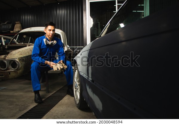 entrepreneur businessman small business owner,\
paint garage, car repair\
shop.