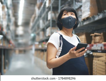 Entrepreneur, Female business Owner in protective face mask holding smartphone in warehouse store while her pregnancy. Young Asian Pregnant Woman buyer using phone and looking at shelf at mall - Powered by Shutterstock