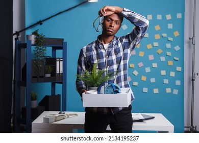 Entrepreneur Getting Fired And Packing Office Things To Leave Job, Feeling Upset And Dissapointed About Dismissal. Jobless Company Worker Carrying Belongings And Thinking About Failed Career.