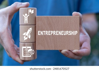 Entrepreneur holding wooden blocks sees word: ENTREPRENEURSHIP. Success Entrepreneurship Business Startup Technology Internet Network concept. Start-up funding crowdfunding investment venture capital.