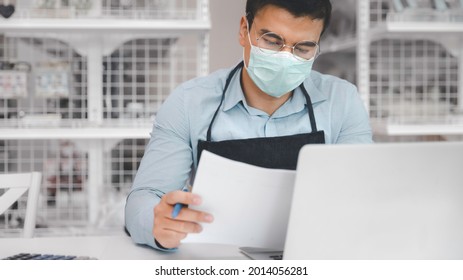 Entrepreneur Male Business Owner In Eyeglasses With Medical Mask Using Computer Laptop Working In Shop Grocery Store, Commercial Crisis Business Debt Concept