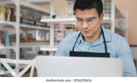 Entrepreneur Male Business Owner In Eyeglasses Using Computer Laptop Working In Grocery Shop Store