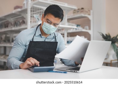 Entrepreneur Male Business Owner In Eyeglasses With Medical Mask Using Computer Laptop Working In Shop Grocery Store, Commercial Crisis Business Debt Concept