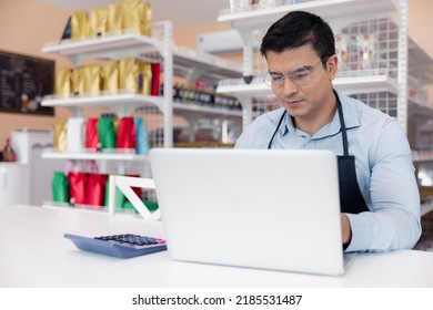 Entrepreneur Male Business Owner In Eyeglasses Using Computer Laptop Working In Grocery Shop Store