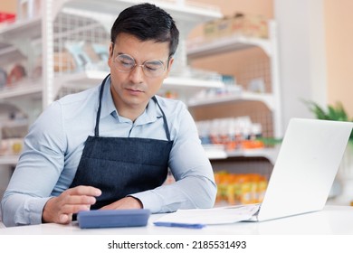 Entrepreneur Male Business Owner In Eyeglasses Using Computer Laptop Working In Grocery Shop Store