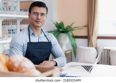 Entrepreneur Male Business Owner In Eyeglasses Using Computer Laptop Working In Grocery Shop Store