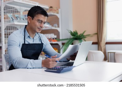 Entrepreneur Male Business Owner In Eyeglasses Using Computer Laptop Working In Grocery Shop Store