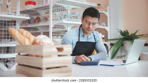 Entrepreneur Male Business Owner In Eyeglasses Using Computer Laptop Working In Grocery Shop Store