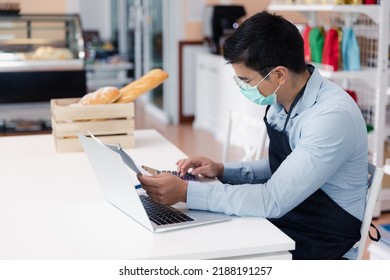 Entrepreneur Male Business Owner In Eyeglasses With Medical Mask Using Computer Laptop Working In Shop Grocery Store, Commercial Crisis Business Debt Concept