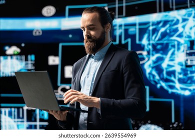 Entrepreneur uses laptop to review artificial intelligence brain system on dashboards, using high tech data visualization for coding, analytics and machine learning. Strategic development.