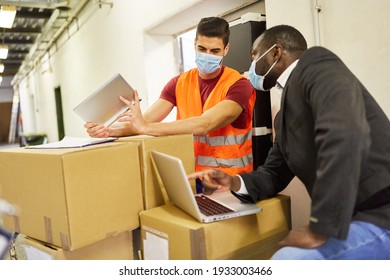 Entrepreneur And Warehouse Clerk Check Packages With Computer For Online Shipping