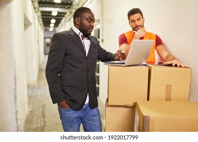 Entrepreneur And Warehouse Clerk On Laptop With Parcels When Shipping In Online Trade