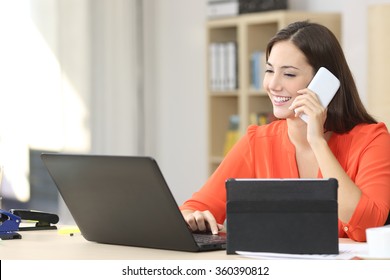 Entrepreneur Working On Line With Multiple Devices In A Desk In A Little Office Or Home