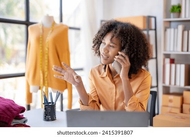 Entrepreneurial African American woman engaging in a phone conversation in her sunny fashion design studio.
 - Powered by Shutterstock