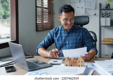 Entrepreneurs, Business Owners, Accountants, Real Estate Agents, A Young Man Using A Calculator To Calculate His Home Budget To Assess The Risks Of Investing In Real Estate.