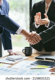 Entrepreneurs collaboration deal shaking hands in a modern office. Business people shaking hands  finishing up a meeting.
