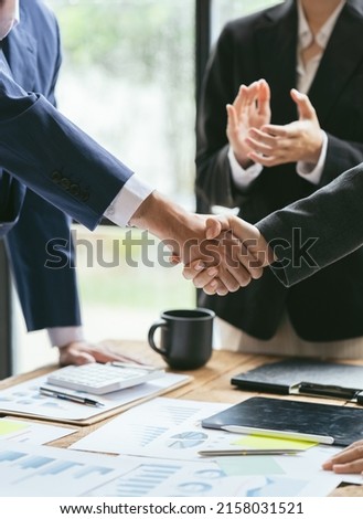 Entrepreneurs collaboration deal shaking hands in a modern office. Business people shaking hands  finishing up a meeting.
