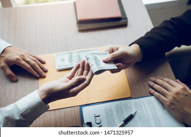 Entrepreneurs are receiving money that is a bribe of their partners with both of whom are corrupt in the company room.
