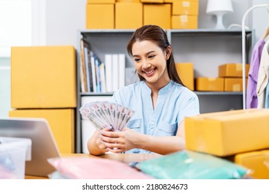 Entrepreneurs Small Business SME Freelance, Young Asian Woman Holding Lot Of US Dollars Money Happy And Proud Smile Work At Home, Online Marketing Packing Box Delivery, Online Sales