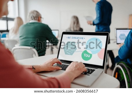 Entrepreneurship program to learn how to start own business. Elderly people attending computer and technology education class.