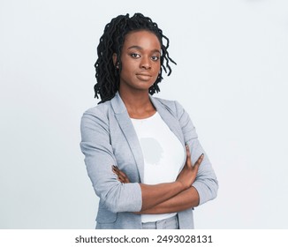 Entrepreneurship. Serious Black Business Girl Looking At Camera Crossing Hands Over White Background. Studio Shot, Free Space