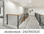 Entry entrance foyer hallway and stair case with wrought iron railings leading into a modern farmhouse style family home.