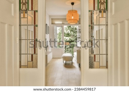 an entry way leading to the living room and dining area with mirrors on either side by side, as seen from the front door