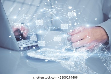 Envelop holograms with businessman working on computer on background. E-mail concept. Multi exposure.