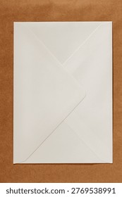Envelope back side placed on a brown textured background with clean minimal composition. Concept of envelope mockup, correspondence, stationery branding, copy space