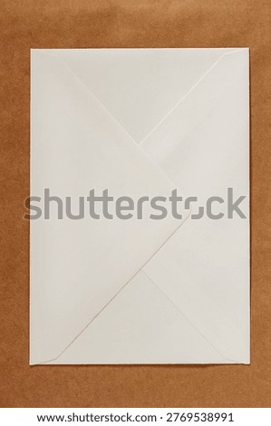 Envelope back side placed on a brown textured background with clean minimal composition. Concept of envelope mockup, correspondence, stationery branding, copy space