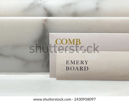 Envelope with a complimentary comb and emery board in a high end luxury hotel with the word, text comb emery board.