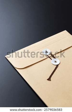 Envelope containing important documents on a black background
