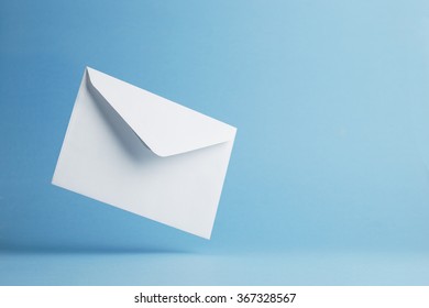 Envelope falling on the ground, blue background with negative space - Shutterstock ID 367328567