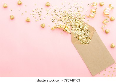 Envelope With Gold Glitter Sequins, Confetti And Hearts On A Gently Pink Background. Mockup Template. View From Above