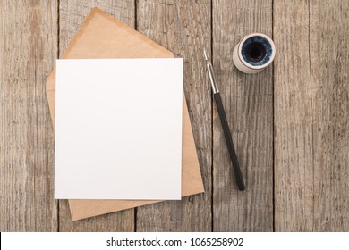 Envelope, ink pen, inkwell on a table  - Shutterstock ID 1065258902