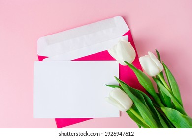 Envelope With Invitation To Holiday And  Bouquet Of Tulips On Pink Background. Place For Text.