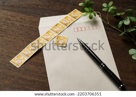 Envelope and Japanese postage stamp on wooden table