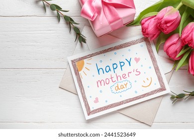 Envelope with kid drawing, gift box and tulips on white wooden background. Happy Mother's Day - Powered by Shutterstock